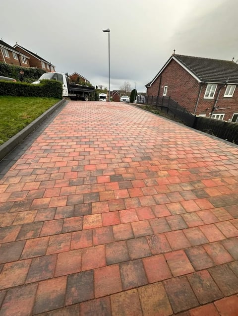 Red brick paved driveway with brick houses in suburban residential area
