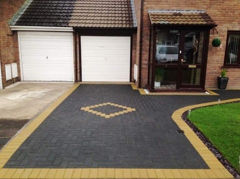 Modern gray herringbone driveway with diamond pattern